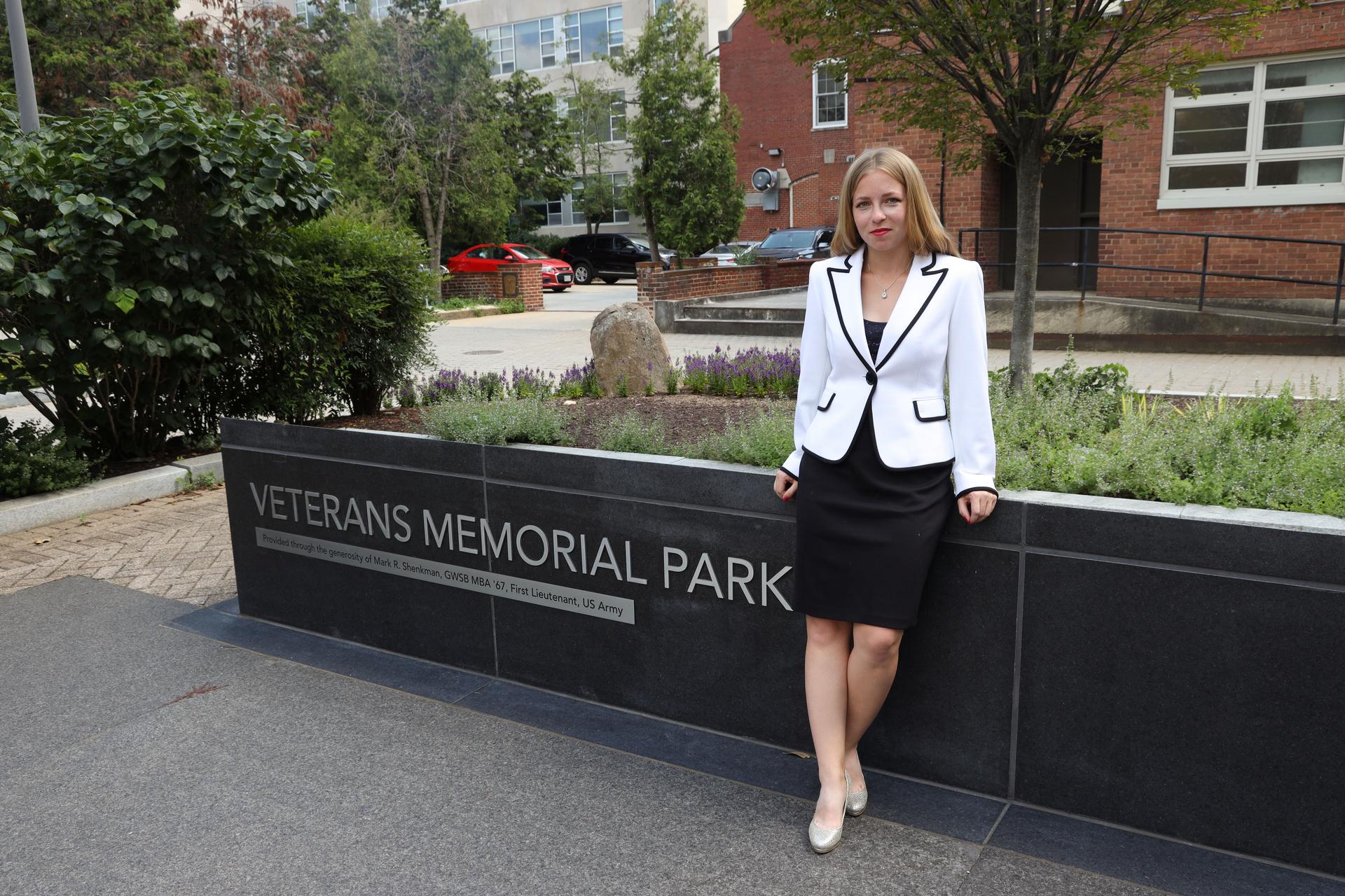 Sarah Malinowski standing in front of Veterans Memorial Park sign
